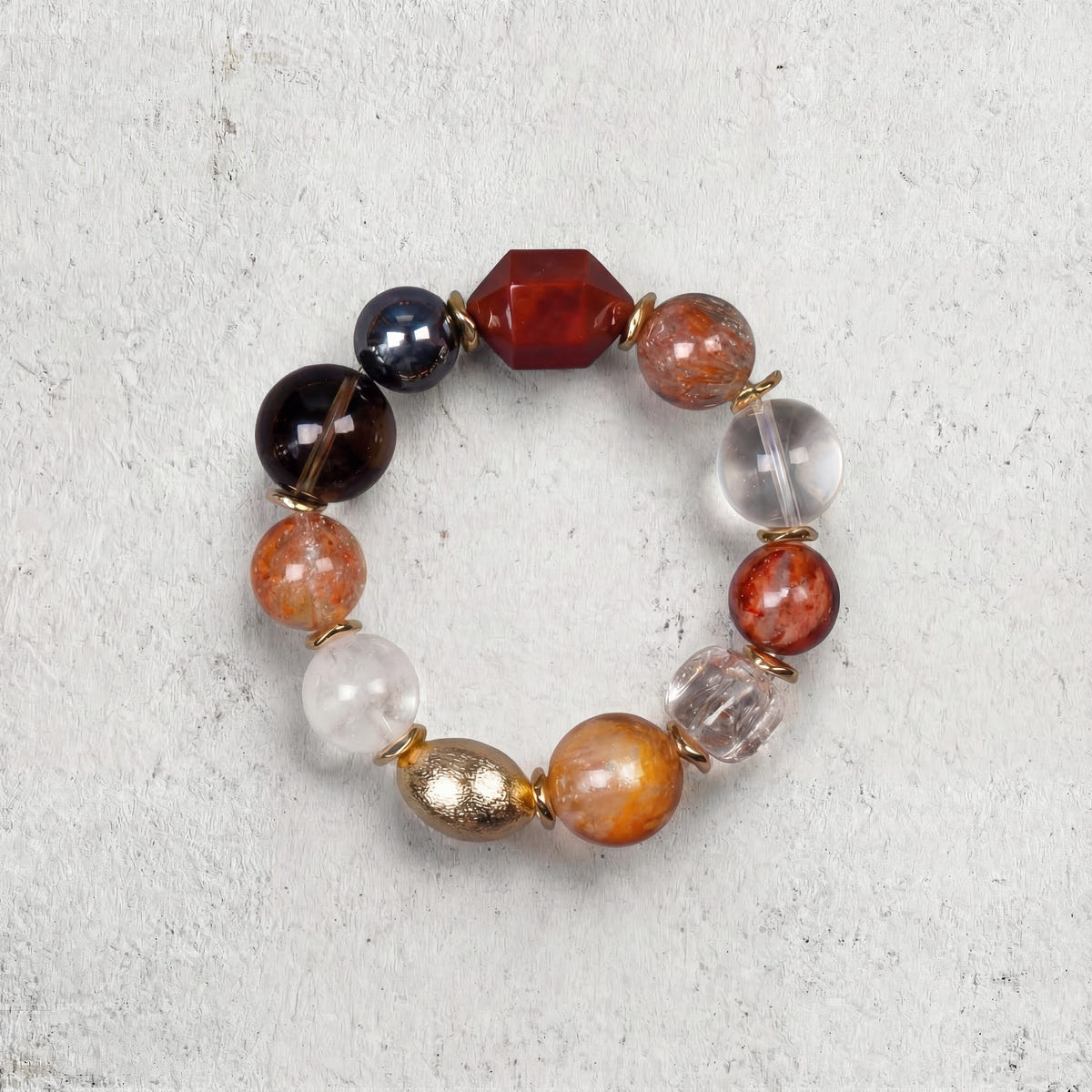 Z06 Omni Matrix bracelet top-down on light gray — dark and amber-colored mixed beads