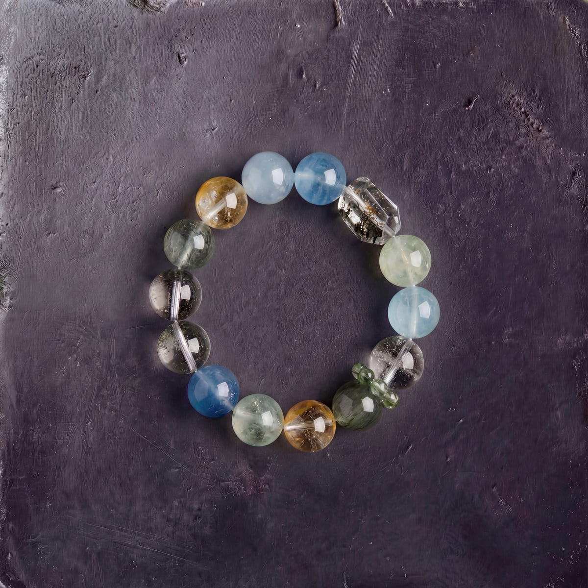Z08 Verdant Bios bracelet — green phantom, prehnite and aquamarine beads, flat lay on dark stone